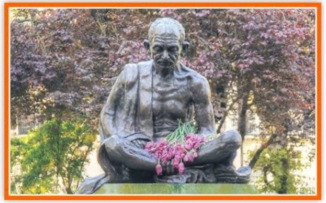 Pic showing the Gandhi statue in Tavistock Square, London with flowers